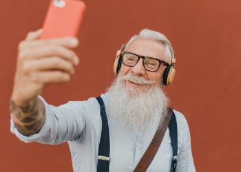 senior man using smartphone for fun
