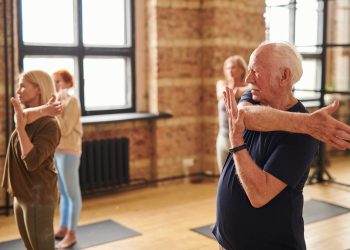 Senior people exercising in health club